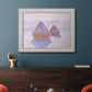 Impressionist winter haystack scene with sunlight by Claude Monet in an ornate weathered white frame displayed in a dark-toned interior setting.