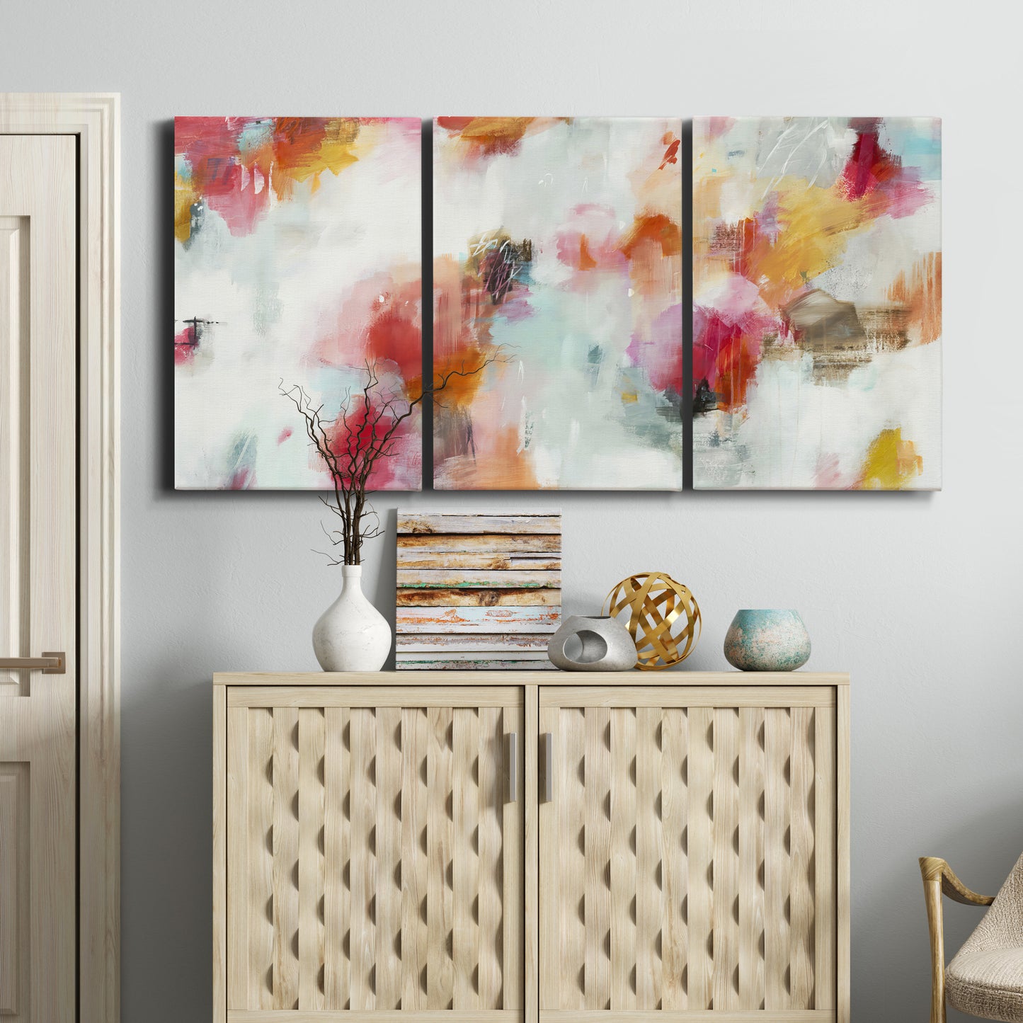 Three-panel canvas wall art featuring abstract directional visual shift, displayed above a cabinet in an entryway.