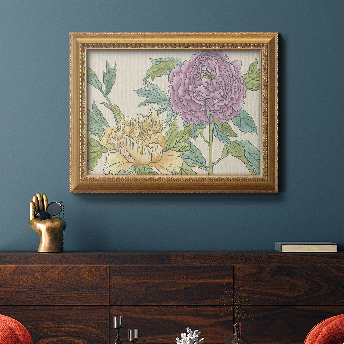 Contemporary peony flower illustration in an ornate antique gold frame displayed in a dark-toned interior setting.