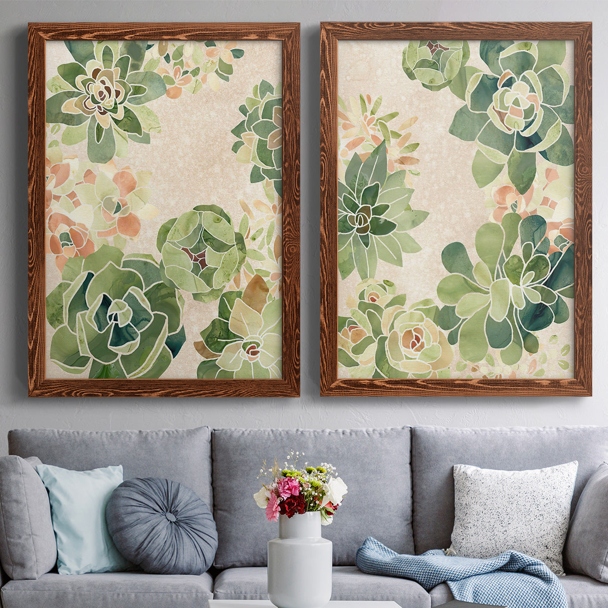 Set of two maple barnwood framed canvas prints depicting paired decorative botanical pattern prints with green rosettes, peach blossoms, and mosaic-like outlines above a sofa in a contemporary living room.