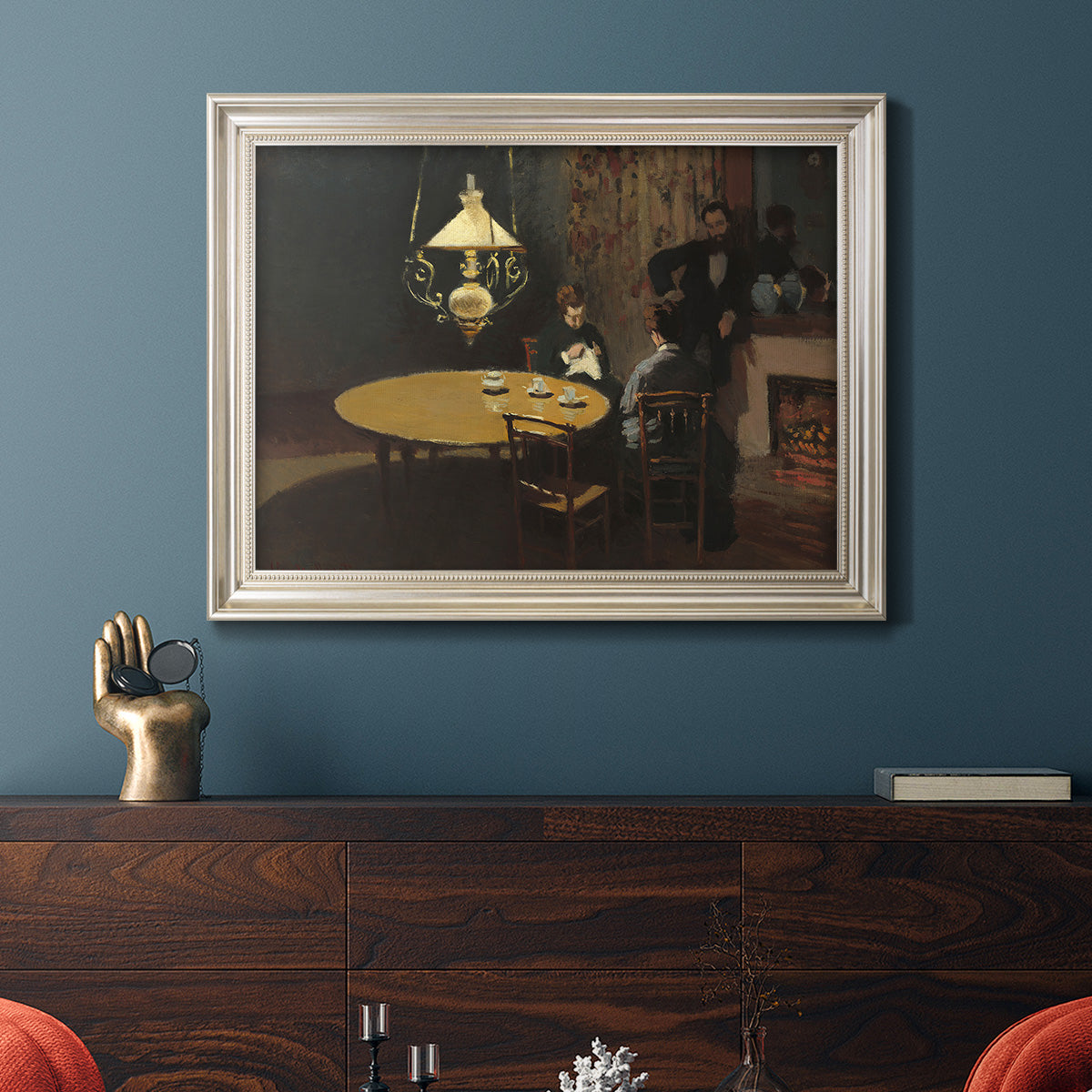 Impressionist domestic interior scene by Claude Monet in an ornate champagne frame displayed in a dark-toned interior setting.