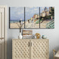 Three-panel canvas wall art featuring figures strolling along beach, displayed above a cabinet in an entryway.