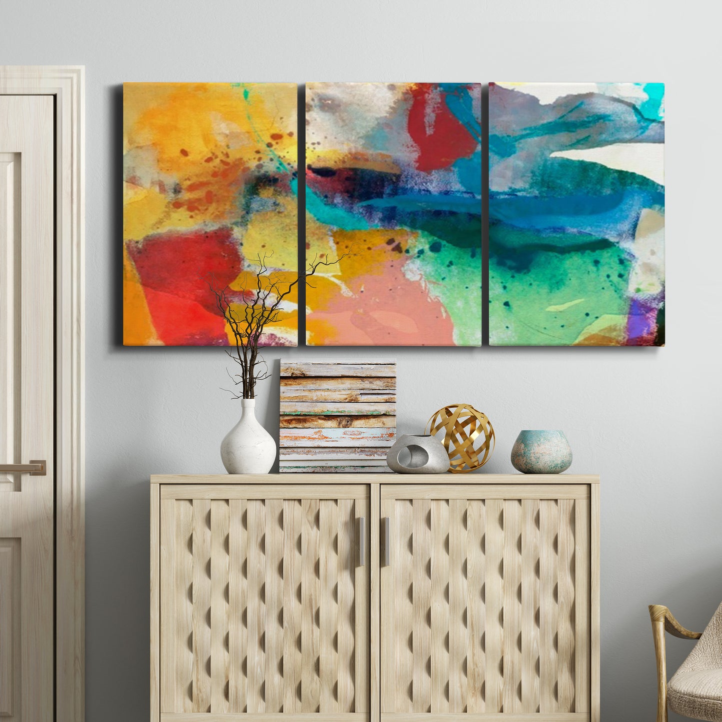 Three-panel canvas wall art featuring layered abstract observational color blocks, displayed above a cabinet in an entryway.