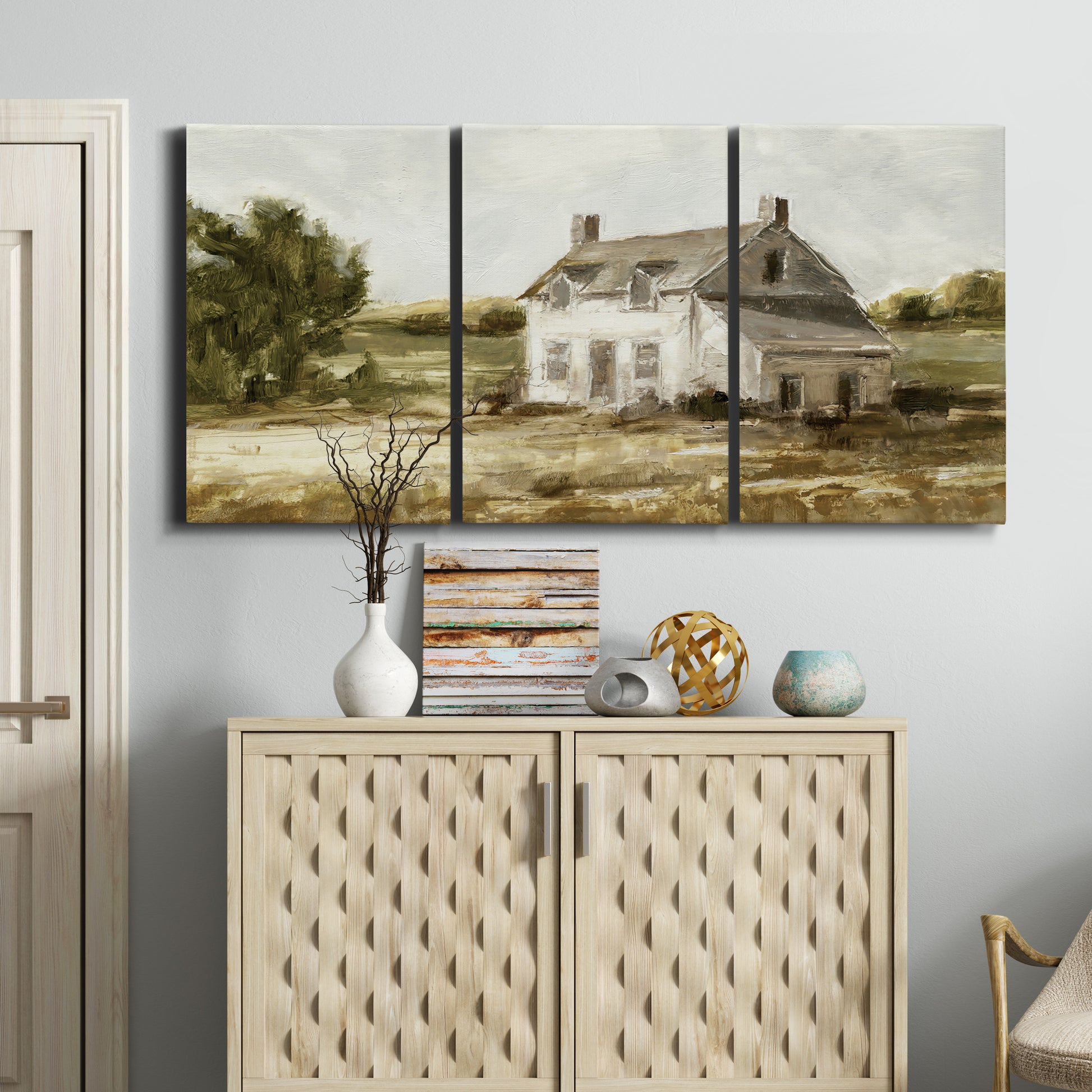 Three-panel canvas wall art featuring rural farmhouse harvest landscape, displayed above a cabinet in an entryway.