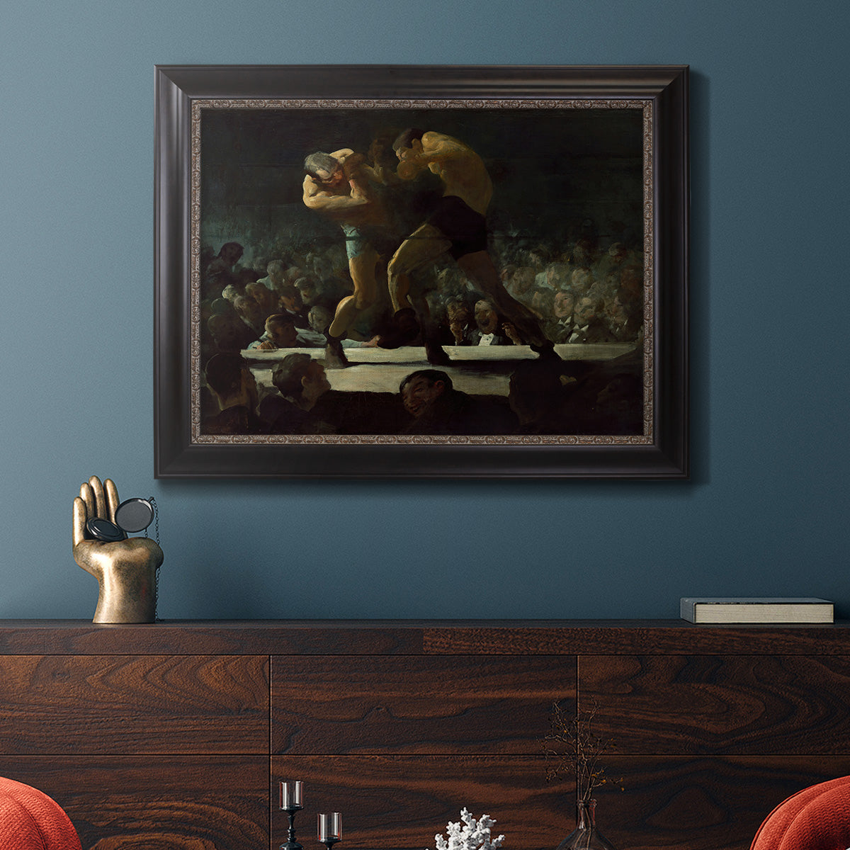 American social club scene painting by George Bellows in an ornate black frame with gilded inner detail displayed in a dark-toned interior setting.