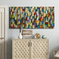 Three-panel canvas wall art featuring colorful confetti style abstraction, displayed above a cabinet in an entryway.