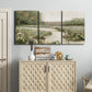 Three-panel canvas wall art featuring narrow path through quiet landscape, displayed above a cabinet in an entryway.