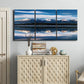 Three-panel canvas wall art featuring calm lake beneath mountains photograph, displayed above a cabinet in an entryway.
