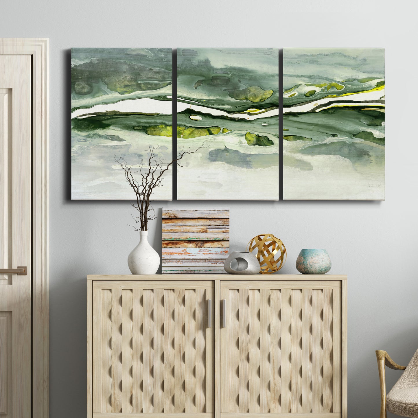 Three-panel canvas wall art featuring abstract passage of time composition, displayed above a cabinet in an entryway.