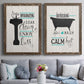 Set of two walnut barnwood framed canvas prints depicting paired graphic bathroom word art with black tubs, hand-lettered phrases, and small teal accents above a sofa in a contemporary living room.