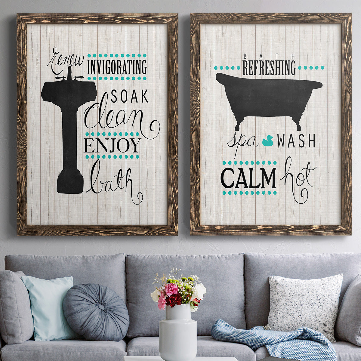 Set of two walnut barnwood framed canvas prints depicting paired graphic bathroom word art with black tubs, hand-lettered phrases, and small teal accents above a sofa in a contemporary living room.