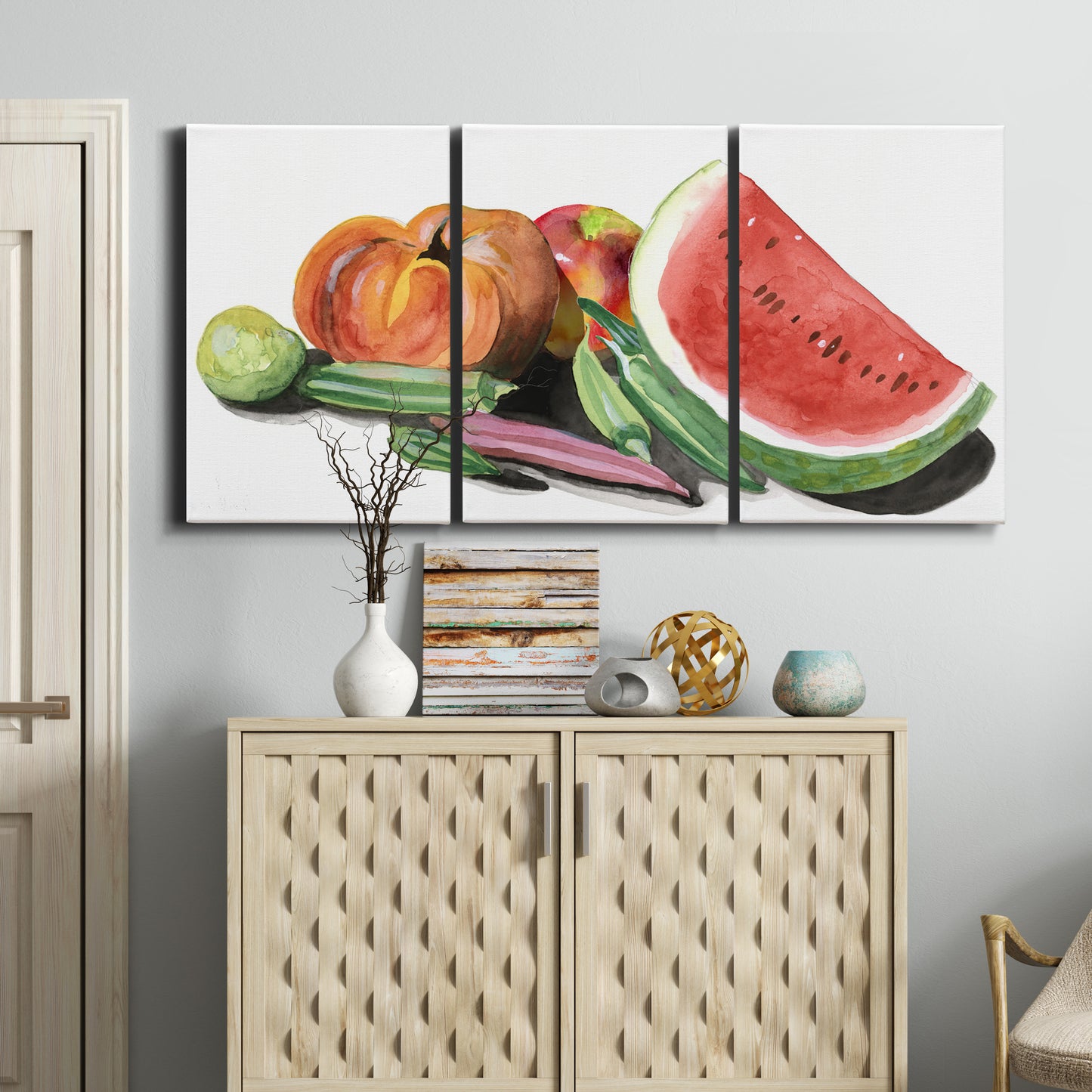 Three-panel canvas wall art featuring impressionist market still life, displayed above a cabinet in an entryway.