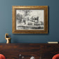 Classical pastoral landscape artwork by Nicolas Berchem in an ornate vintage gold frame displayed in a dark-toned interior setting.