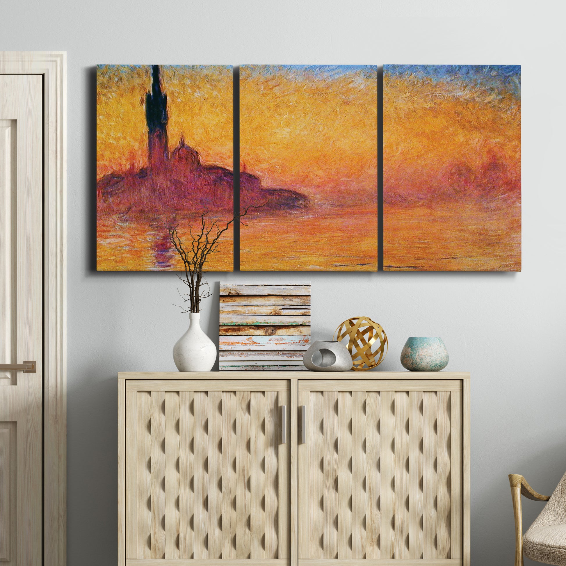 Three-panel canvas wall art featuring venetian church at twilight, displayed above a cabinet in an entryway.