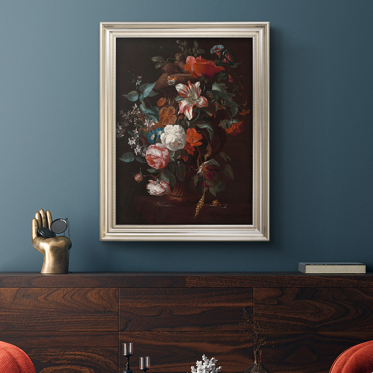 Classical floral still life painting by Jan van Huysum in an ornate champagne frame displayed in a dark-toned interior setting.