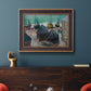 Impressionist coastal beach scene with boats by Claude Monet in an ornate bronzed mahogany wood frame displayed in a dark-toned interior setting.