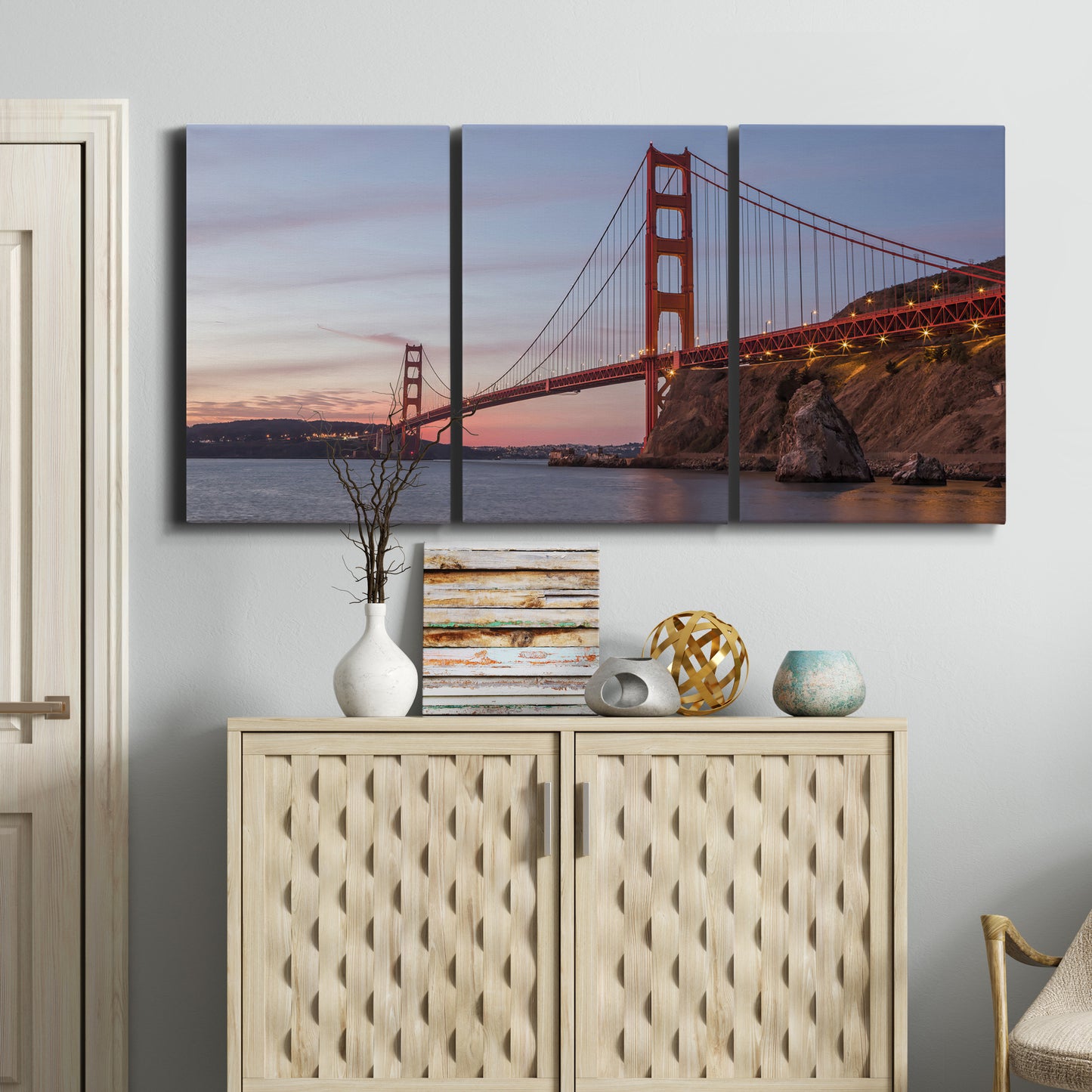 Three-panel canvas wall art featuring golden gate bridge spanning bay, displayed above a cabinet in an entryway.