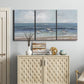 Three-panel canvas wall art featuring shore birds searching along beach, displayed above a cabinet in an entryway.