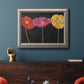 Contemporary poppy flower artwork in an ornate vintage silver frame displayed in a dark-toned interior setting.