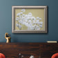 Minimal floral baby’s breath photography in an ornate vintage silver frame displayed in a dark-toned interior setting.