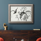 Asian-inspired lotus flower illustration in an ornate vintage silver frame displayed in a dark-toned interior setting.