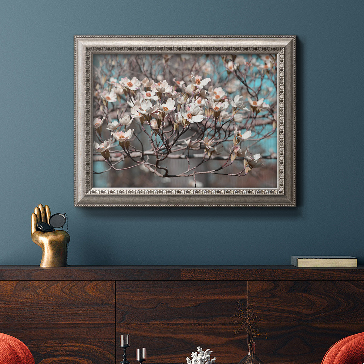 Modern spring dogwood flower photograph in an ornate vintage silver frame displayed in a dark-toned interior setting.
