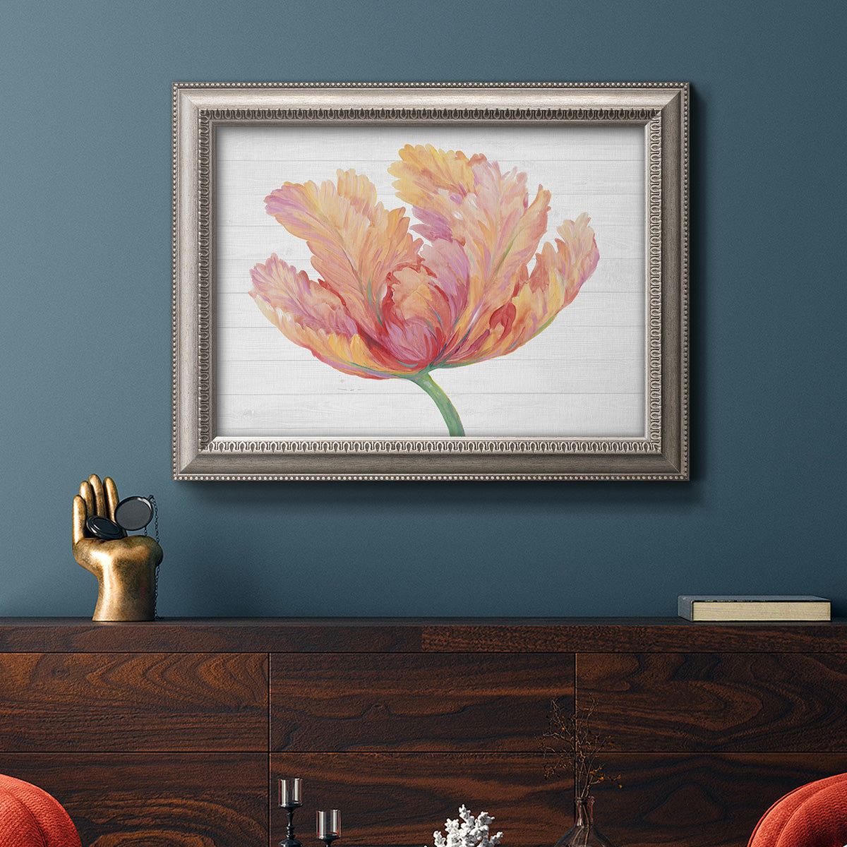 Modern minimalist pink floral artwork in an ornate vintage silver frame displayed in a dark-toned interior setting.