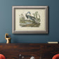 Antique Louisiana heron bird illustration by John James Audubon in an ornate vintage silver frame displayed in a dark-toned interior setting.