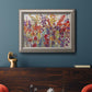 Impressionist floral bouquet artwork in an ornate vintage silver frame displayed in a dark-toned interior setting.