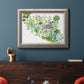 Contemporary abstract succulent botanical watercolor in an ornate vintage silver frame displayed in a dark-toned interior setting.