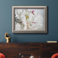 White peony close-up photography in an ornate vintage silver frame displayed in a dark-toned interior setting.