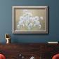 Botanical baby’s breath flower photography in an ornate vintage silver frame displayed in a dark-toned interior setting.