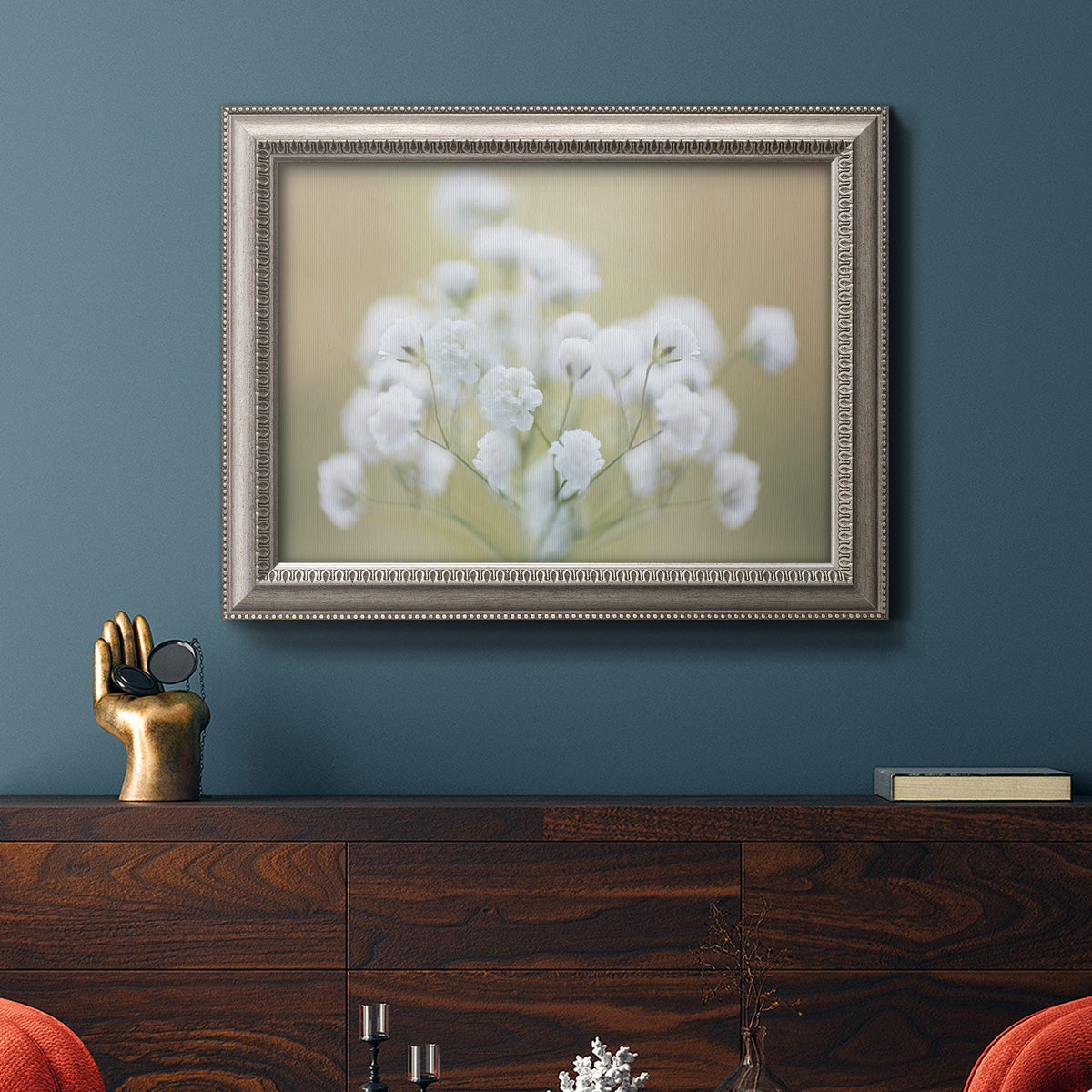 Botanical baby’s breath flower photography in an ornate vintage silver frame displayed in a dark-toned interior setting.