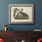 Antique reddish egret bird illustration by John James Audubon in an ornate vintage silver frame displayed in a dark-toned interior setting.
