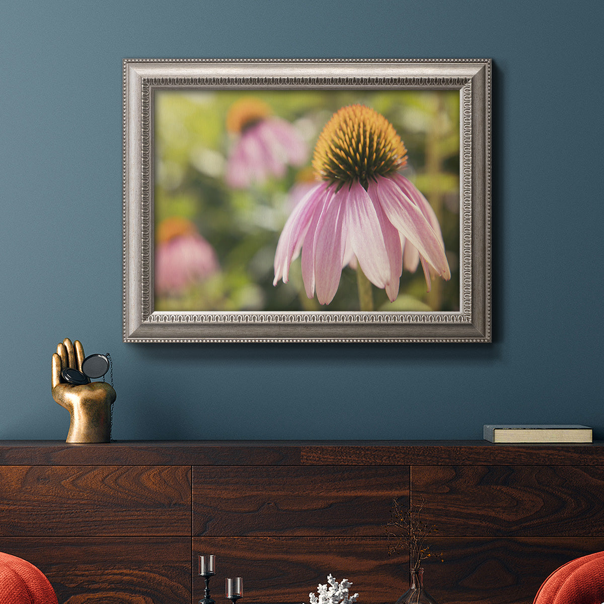 Echinacea flower botanical photography in an ornate vintage silver frame displayed in a dark-toned interior setting.