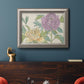 Contemporary peony flower illustration in an ornate vintage silver frame displayed in a dark-toned interior setting.