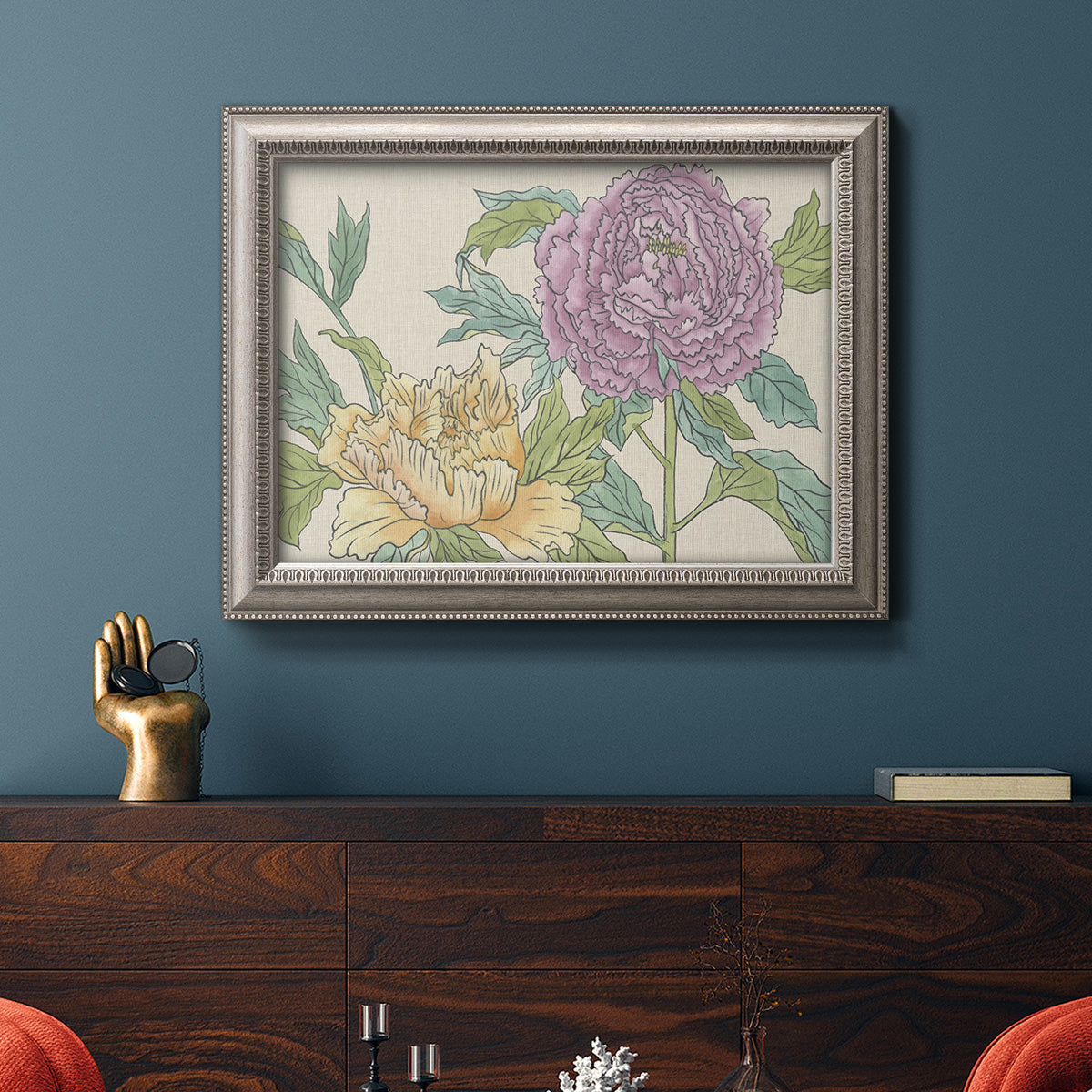 Contemporary peony flower illustration in an ornate vintage silver frame displayed in a dark-toned interior setting.