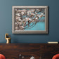 Color-rich dogwood floral photography in an ornate vintage silver frame displayed in a dark-toned interior setting.