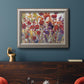 French country floral bouquet painting in an ornate vintage silver frame displayed in a dark-toned interior setting.