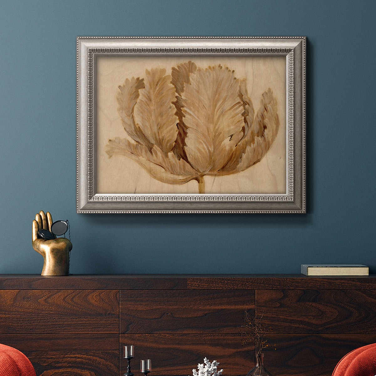 Monochrome sepia tulip flower in an ornate vintage silver frame displayed in a dark-toned interior setting.