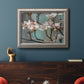 Close-up dogwood blossom photography in an ornate vintage silver frame displayed in a dark-toned interior setting.