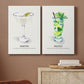Matching vertical canvas prints of vintage martini cocktail illustration displayed against a darker accent wall.