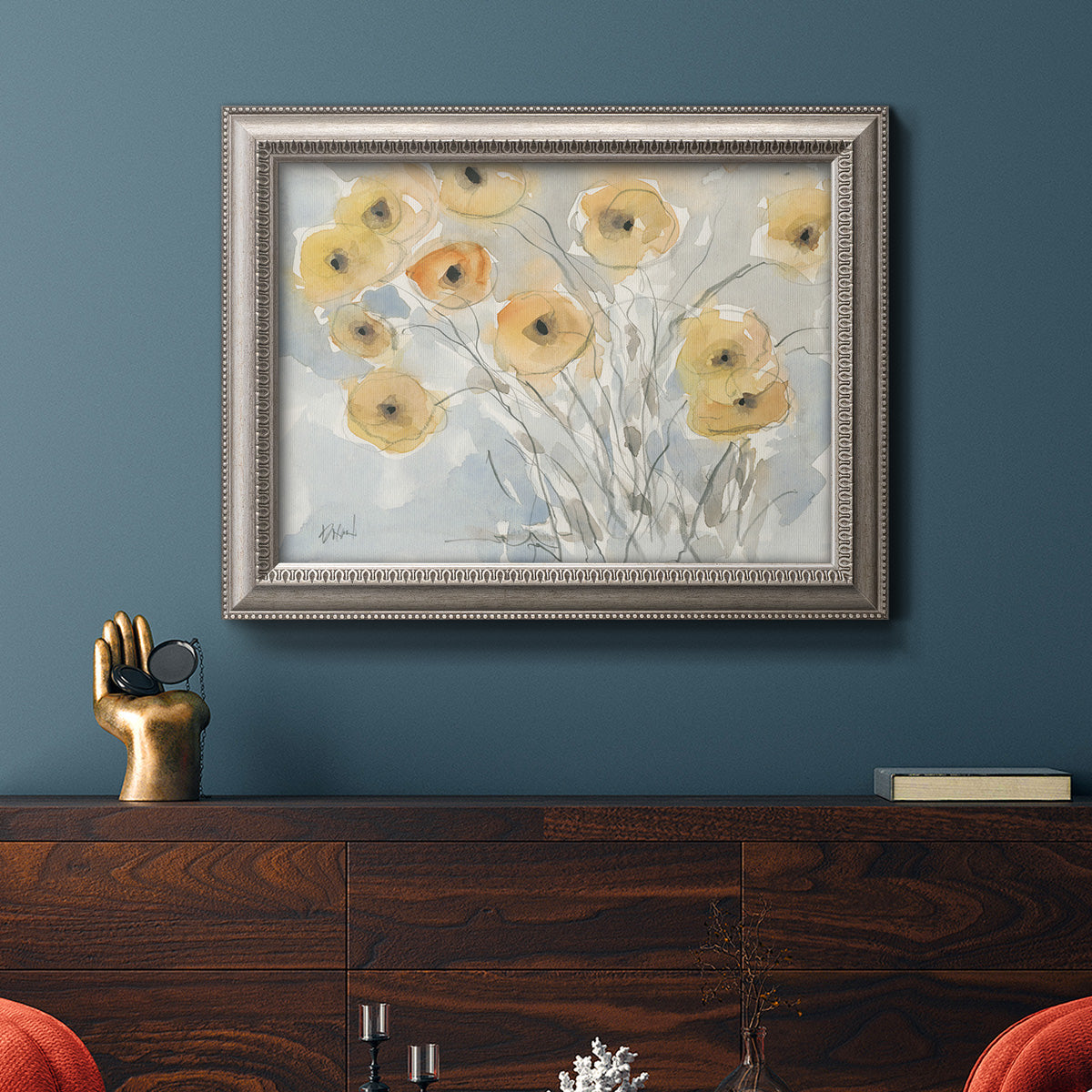 Impressionist poppy floral watercolor painting in an ornate vintage silver frame displayed in a dark-toned interior setting.