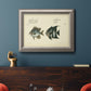 Antique fish chart illustration in an ornate vintage silver frame displayed in a dark-toned interior setting.