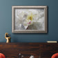 Neutral white peony photography in an ornate vintage silver frame displayed in a dark-toned interior setting.
