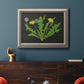 Vintage botanical dandelion flower illustration in an ornate vintage silver frame displayed in a dark-toned interior setting.