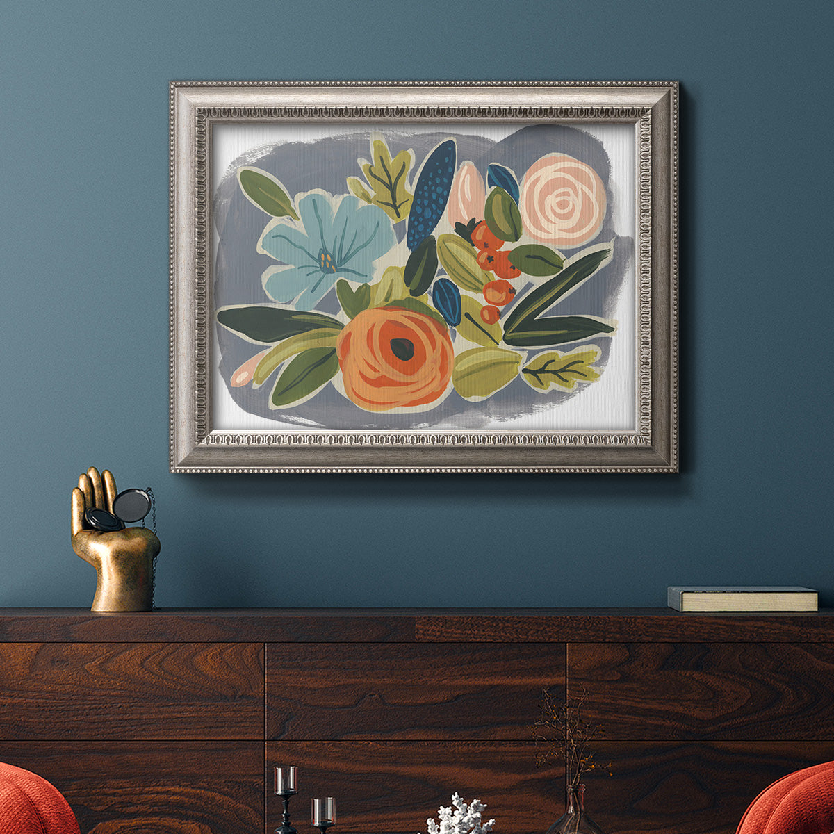 Bold modern botanical illustration in an ornate vintage silver frame displayed in a dark-toned interior setting.