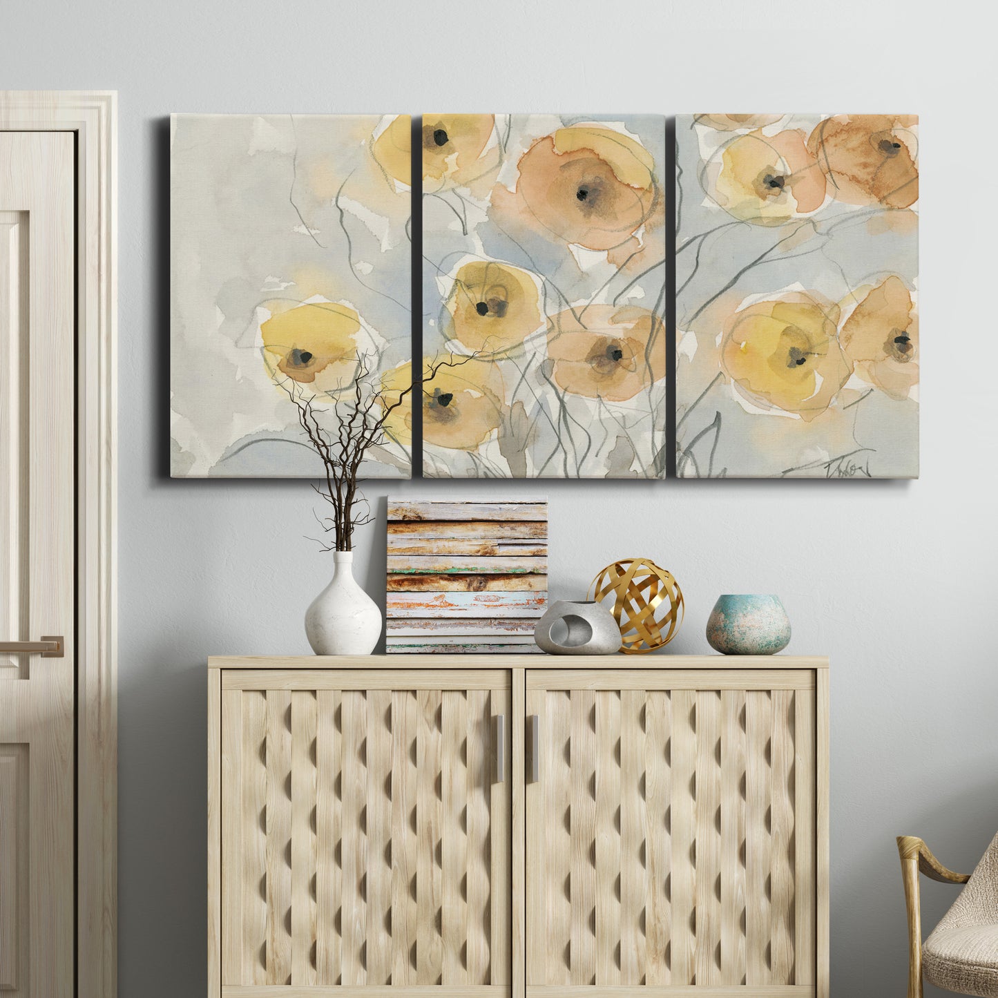 Three-panel canvas wall art featuring minimalist poppies at sunset, displayed above a cabinet in an entryway.
