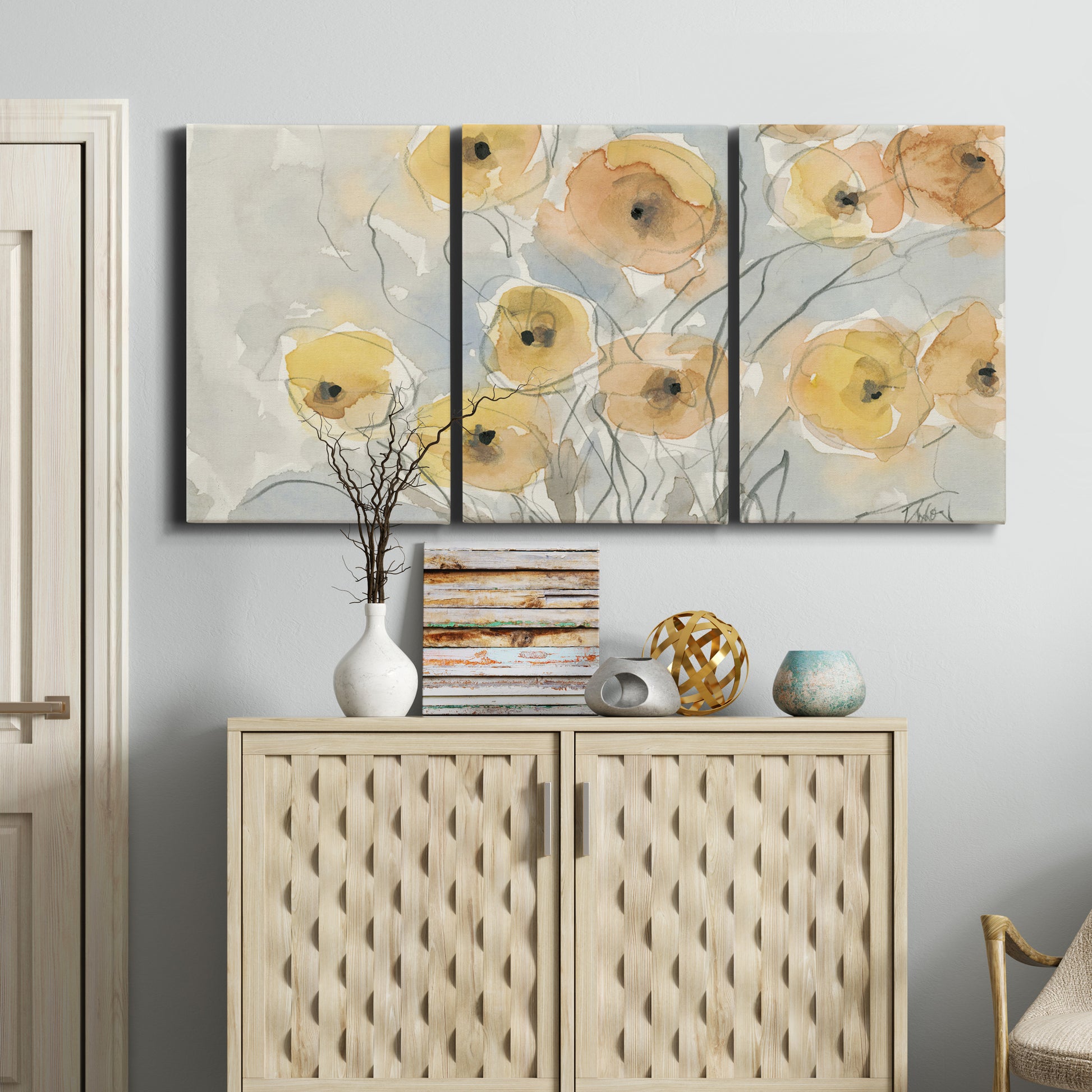 Three-panel canvas wall art featuring minimalist poppies at sunset, displayed above a cabinet in an entryway.
