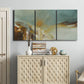 Three-panel canvas wall art featuring earth toned abstract solar landscape, displayed above a cabinet in an entryway.